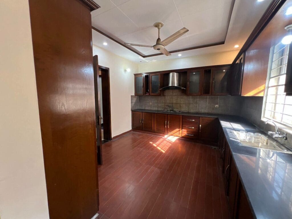 Kitchen with Wooden Cabinets – 15 Marla House Valancia Society Lahore Title: