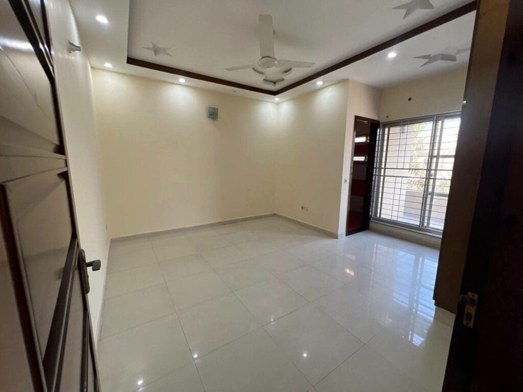 Bedroom with Tile Flooring and Built-in Wardrobes – 15 Marla House Valancia Society Lahore