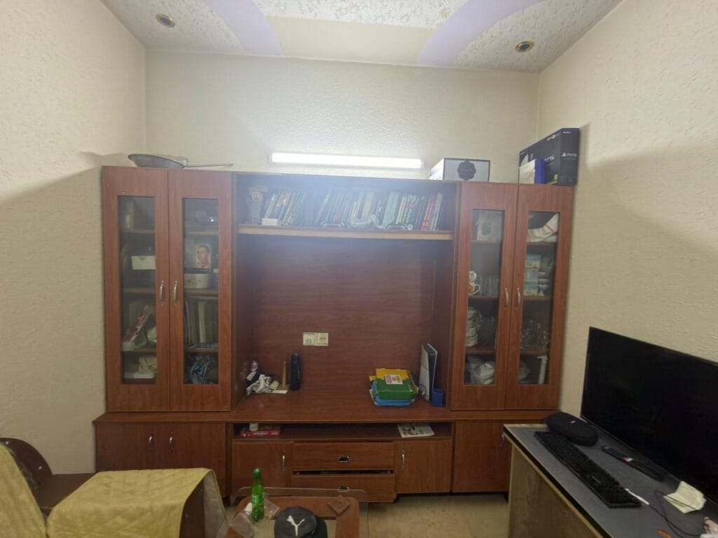 TV Lounge with Wooden Shelving – 3.5 Marla House Johar Town Lahore