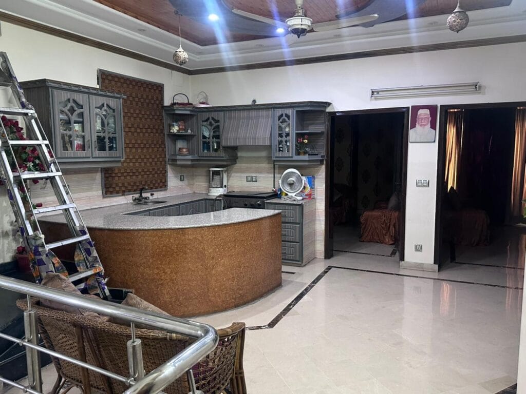 Open Kitchen with cabinets and stove in 10 Marla house for sale in Punjab Govt. Society Phase 2, Lahore