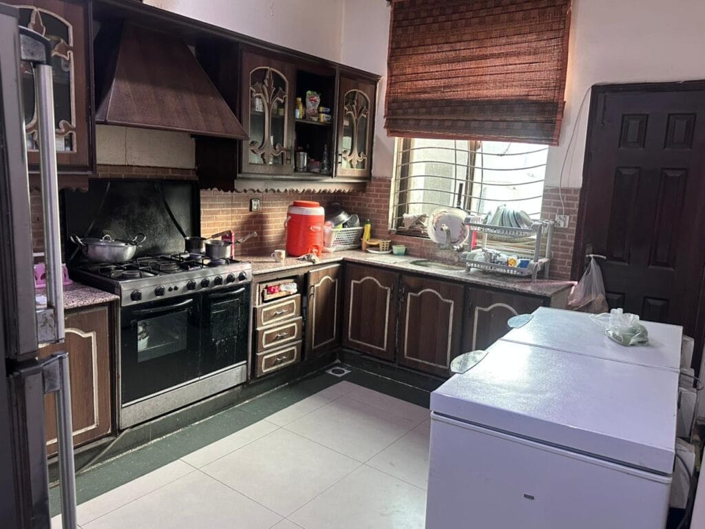 Kitchen with cabinets and stove in 10 Marla house for sale in Punjab Govt. Society Phase 2, Lahore