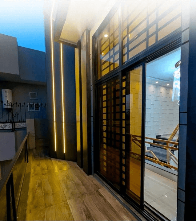1 Kanal house for sale in IEP Town Sector A, Lahore - balcony with wooden flooring and designer glass door